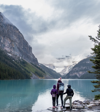 People looking out over an alpine lake